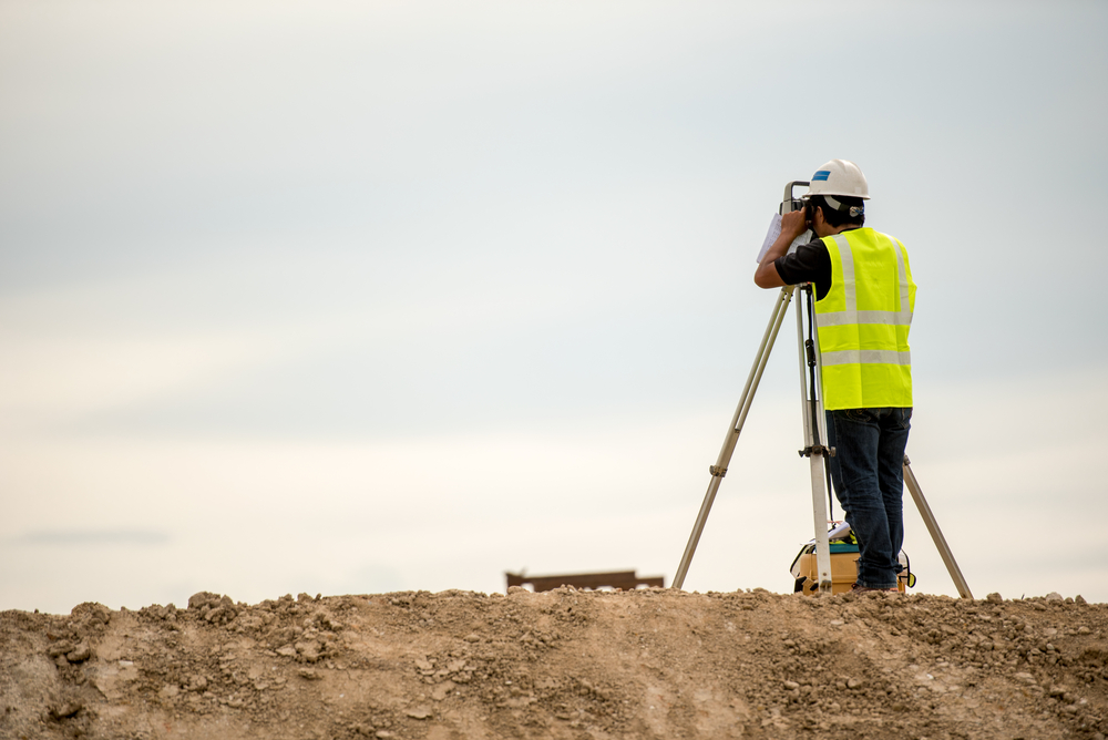 Survey,Engineer,In,Construction,Site,Use,Theodolite,Mark,A,Concrete